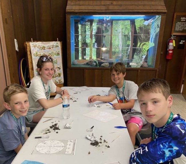 kids at a work table at summer camp