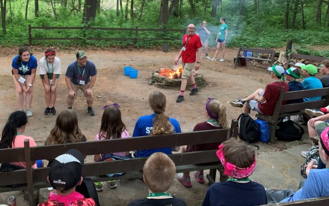 summer camp activities around a campfire