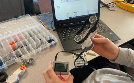 youth assembling a lego robotics kit