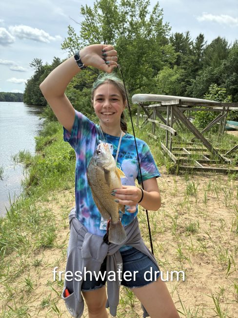 girl with a fish on a fishing line