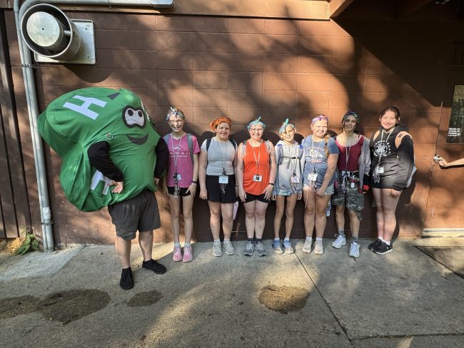 group of children standing alongside a building