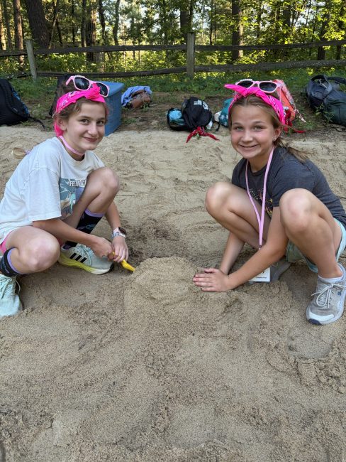 Two girls playing in sand