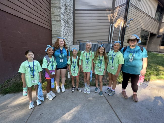 group of children wearing camp tee shirts