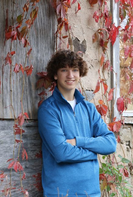 young man leaning against a wall