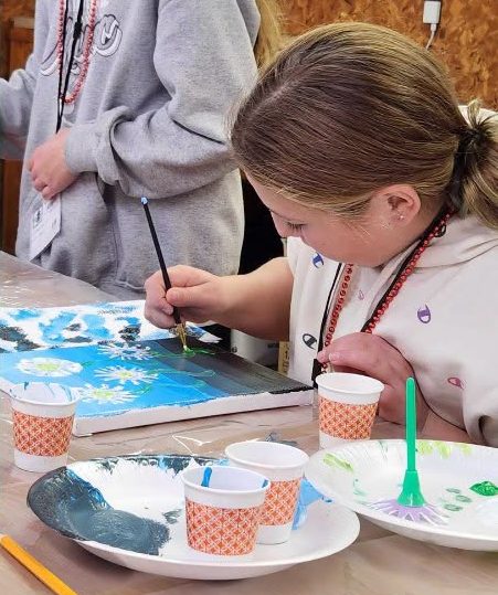 girl painting on a canvas
