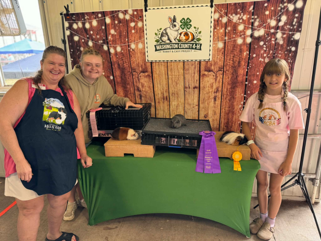 4-H members & leader with their cavy project at the county fair
