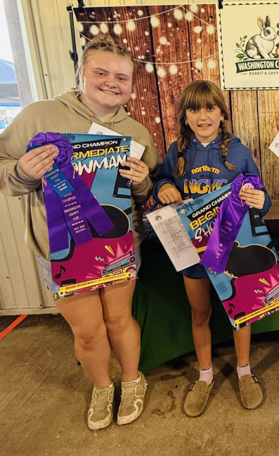two 4-H youth with fair ribbons